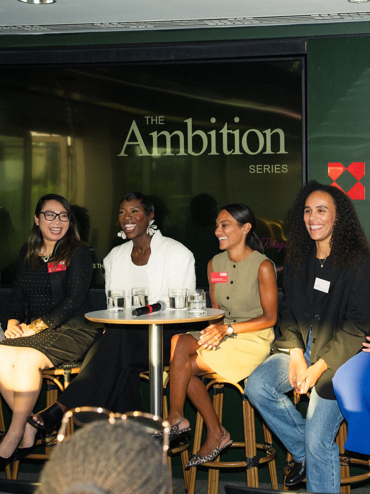 The panel on stage in front of the Ambition Series backdrop